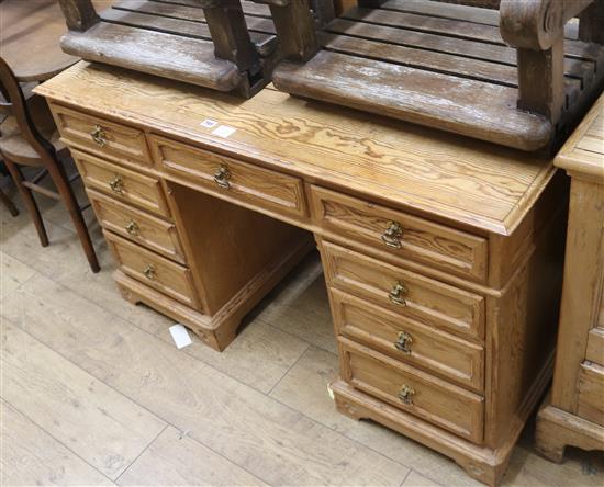 A pine pedestal desk, fitted nine small drawers W.122cm